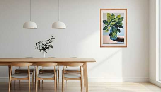 Dining room with wooden table, chairs, and a framed leaves in blue glass on the wall art print