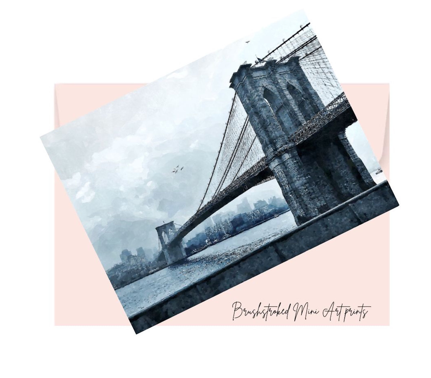black and white mini art print of the Brooklyn bridge on top of a pink envelope for posting.