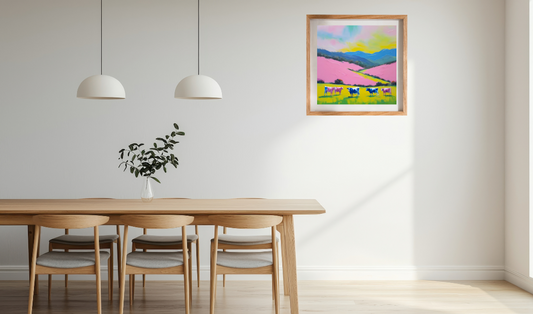 Dining room with wooden table and chairs, colorful abstract landscape with cows painting on the wall.