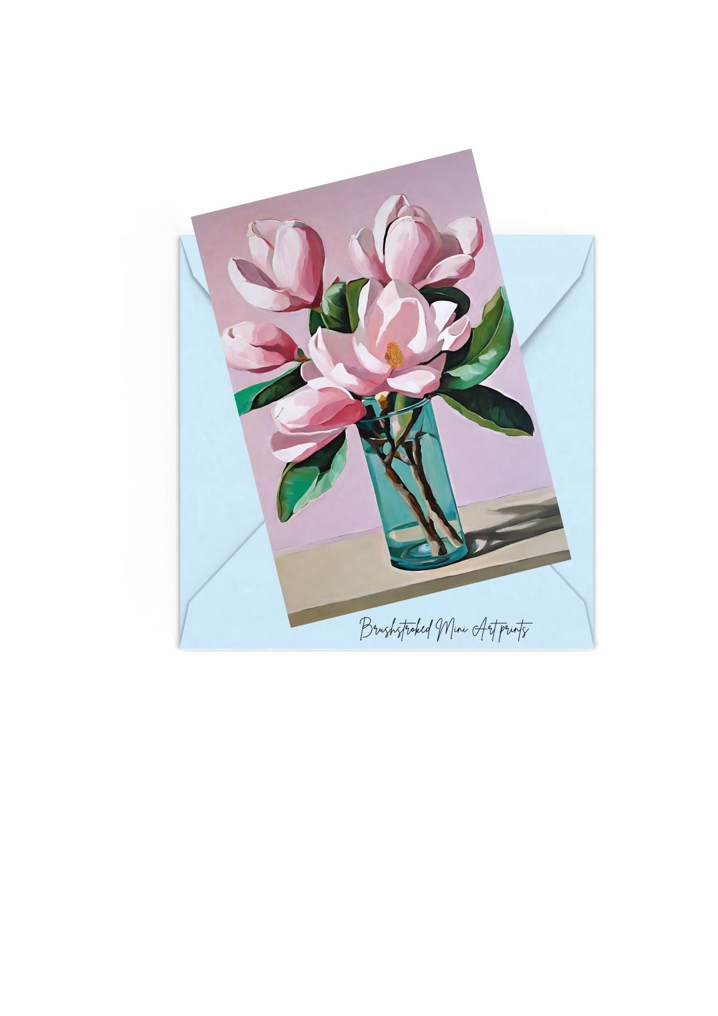 Pink Magnolias in blue glass vase mini art print on top of Blue envelope