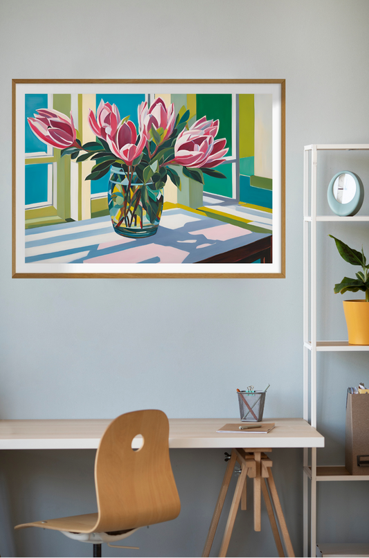 Pink Proteas flowers in glass vase painting hanging on wall above desk.