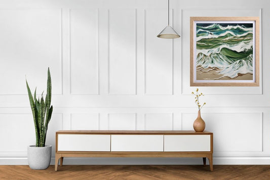 seascape painting with blue, green and white waves and sand framed and hanging on a wall