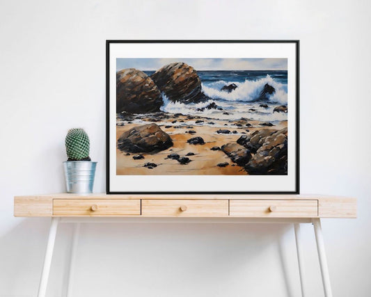 seascape rocks, sand, waves blue sky art print framed and sitting on desk.