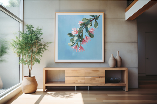 Modern interior with wooden sideboard, plant, and floral artwork on wall.