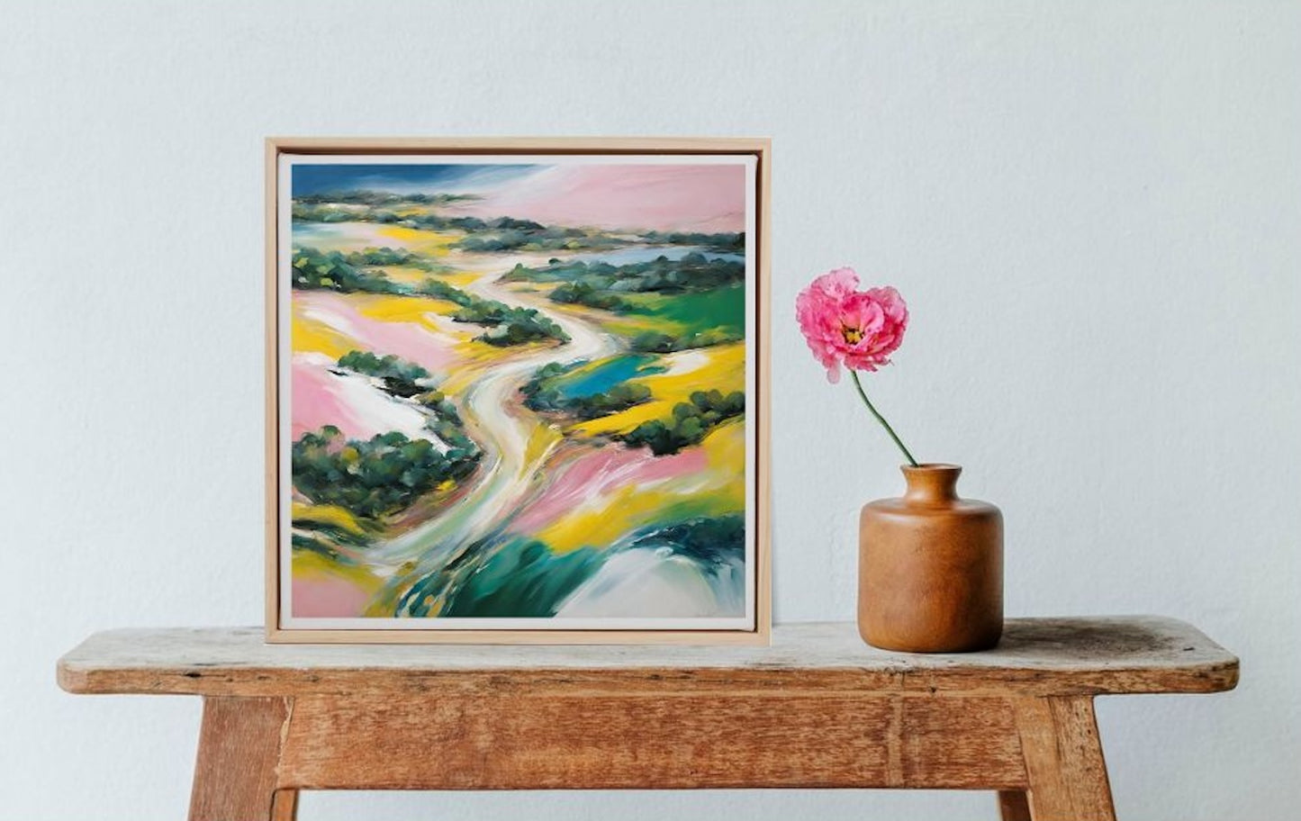 abstract colourful landscape art in frame on table
