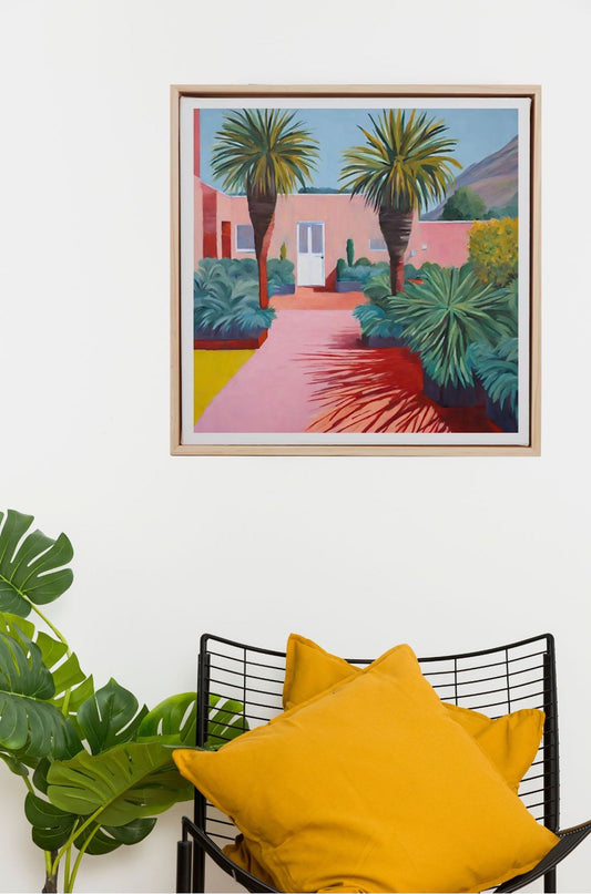 palm springs, california, pink house with palm trees art print framed in wood, hanging on wall.