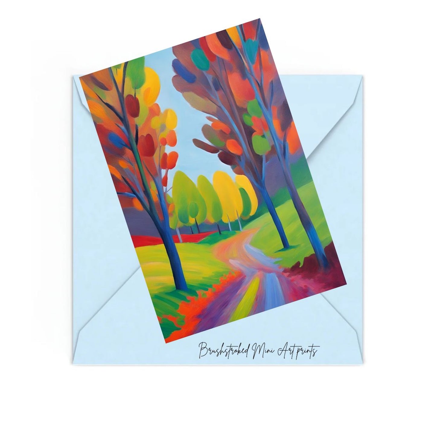 COlourful forest landscape with path and trees mini art print on top of a blue envelope