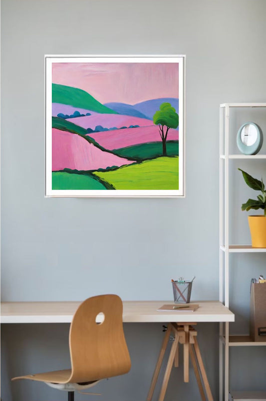 Framed colorful landscape painting on a wall above a desk with a chair.