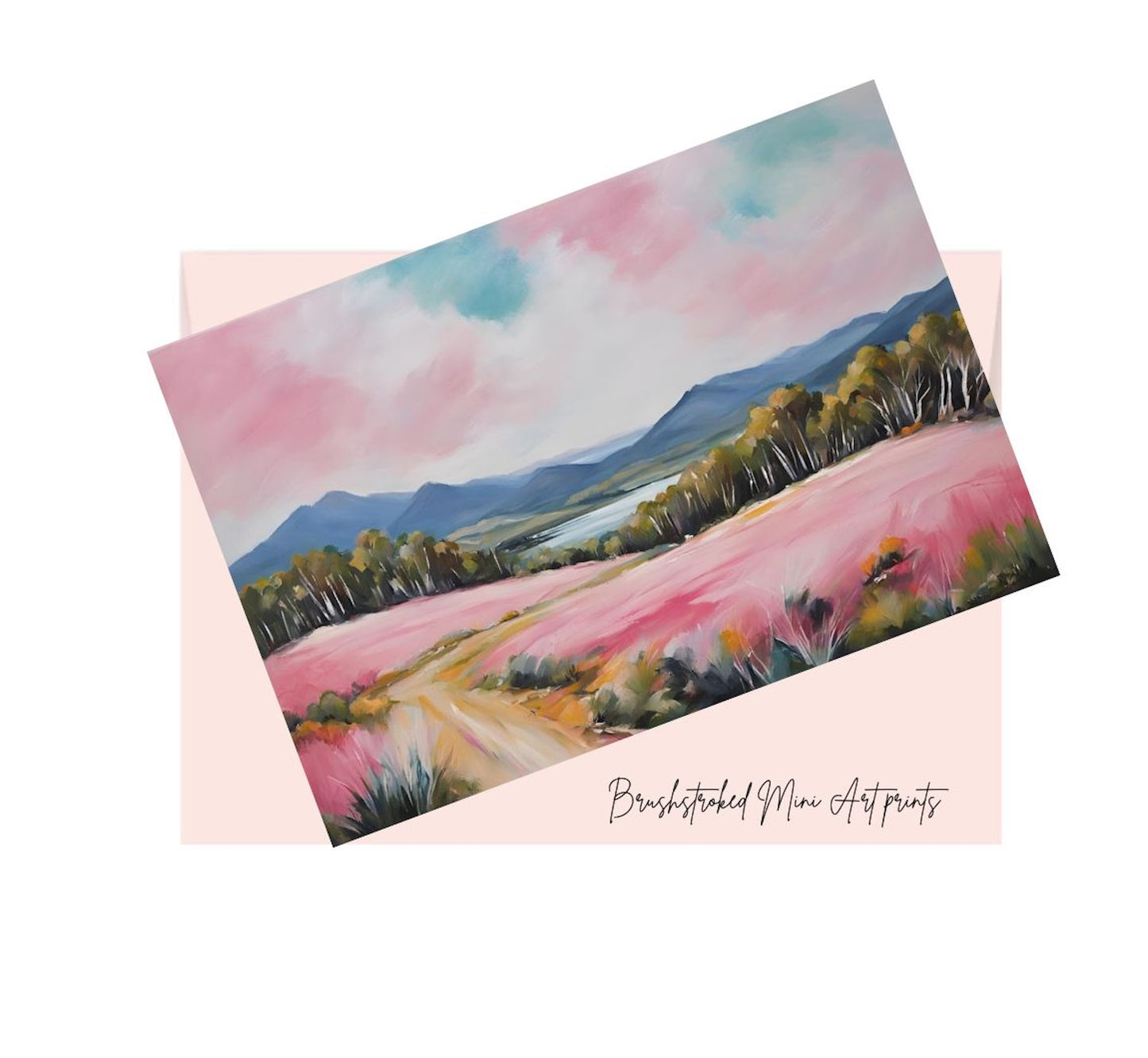 mini art print of a pastel australian landscape hills pink flower fields trees, on top of a pink envelope