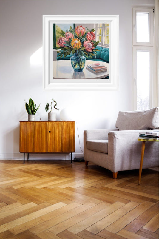 pink_Proteas_in_blue_vase_art_print hanging on a wall.