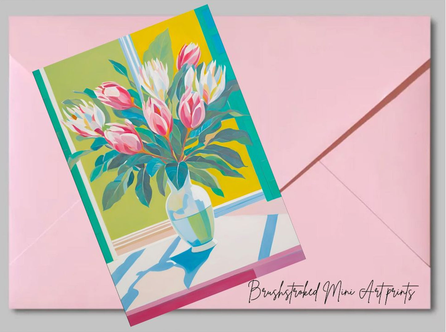 mini art print of proteas in vase near green window on top of a pink envelope