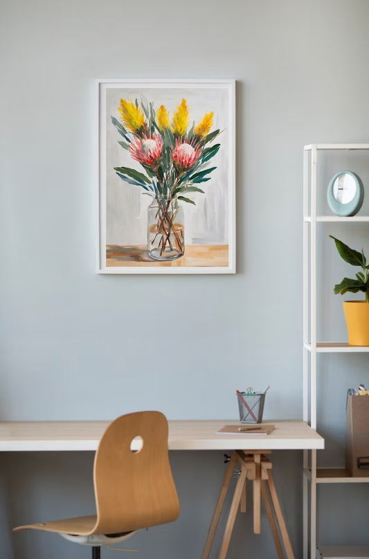 yellow wattle and pink proteas in glass vase framed and hanging on wall