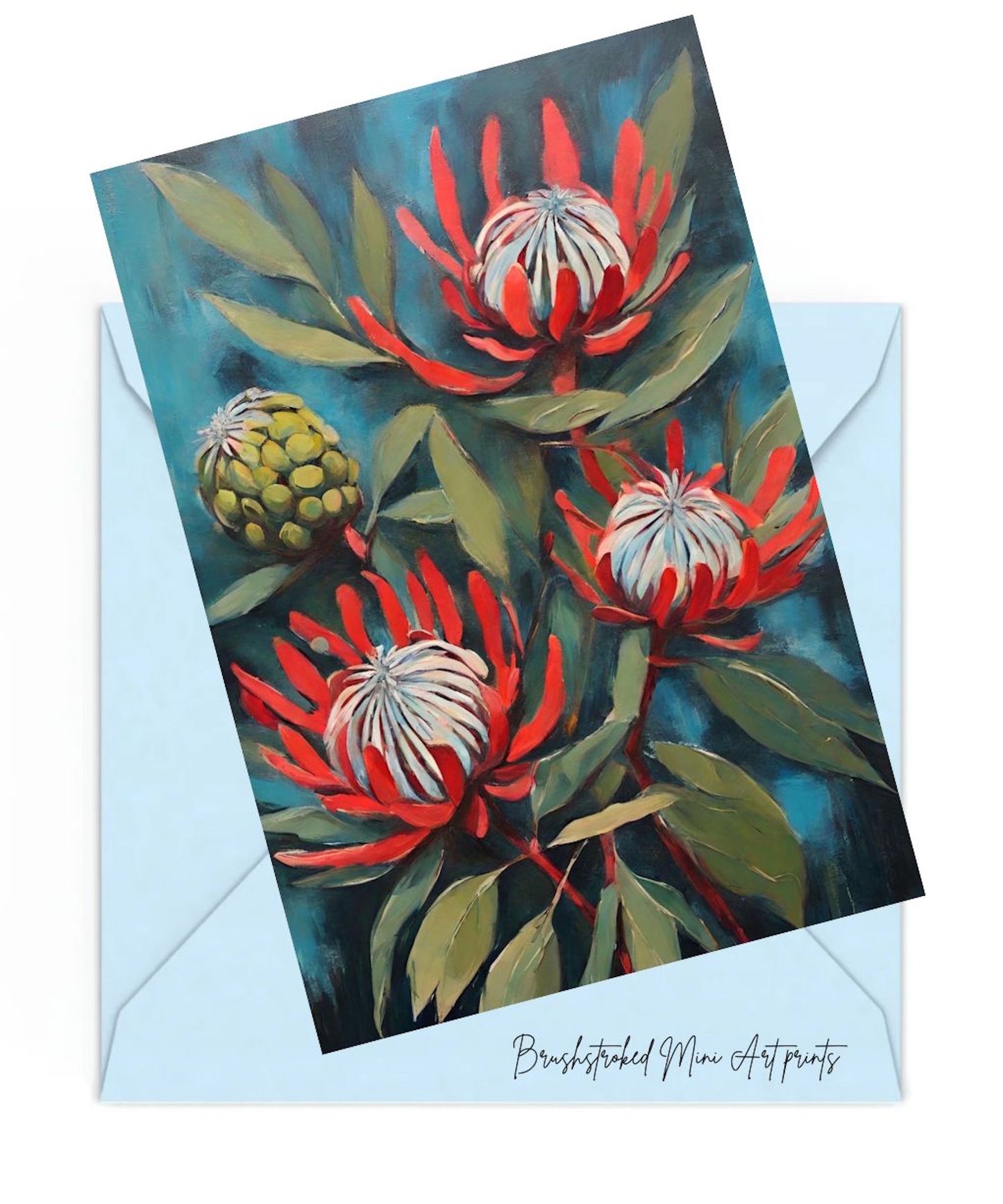 red proteas and green leaves painted on a blue background mini art print on top of a blue envelope