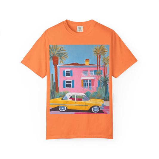 orange t shirt printed on the front with a colourful palm springs pink house and a yellow vintage car.