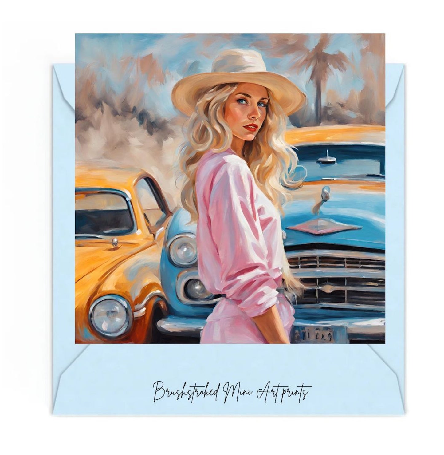 woman wearing pink dress and wearing a straw hat in front of two vintage cars mini art print