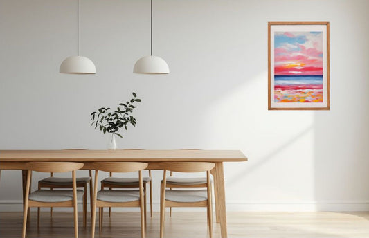 Abstract colourful seascape sunset framed and hanging on the wall in a dining setting.