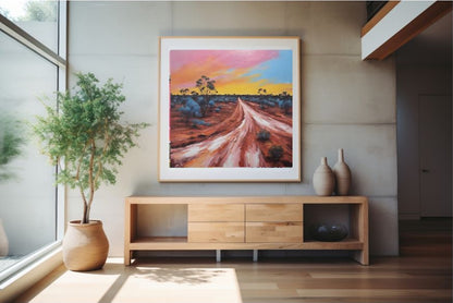 Australian abstract dessert landscape print framed and hanging on wall over cabinet.