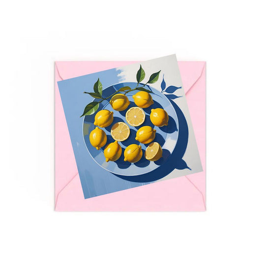 Lemons on blue plate art print on top of a Pink envelope