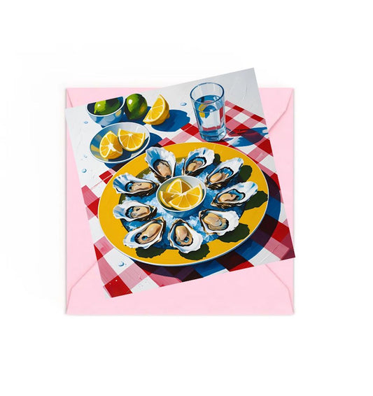 Mini art print of Oysters on Yellow plate with lemons and limes on red and white check table cloth, on top of a Pink envelope.