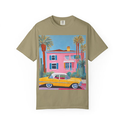 Sage coloured short sleeved T- shirt printed with a colourful palm springs house and yellow vintage car.