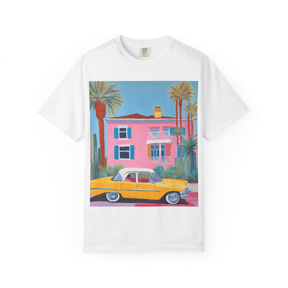 white t shirt printed on the front with a colourful palm springs pink house and a yellow vintage car.