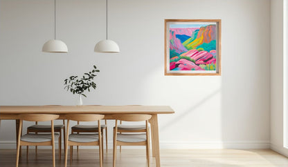 Dining room with a wooden table and chairs, colourful abstract  seascape painting on the wall, and two pendant lights.