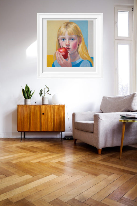 girl-blondehair-eating_apple_art_print framed and hanging on wall