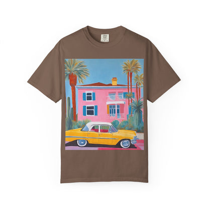 Chocolate coloured t shirt printed on the front with a colourful palm springs pink house and a yellow vintage car.