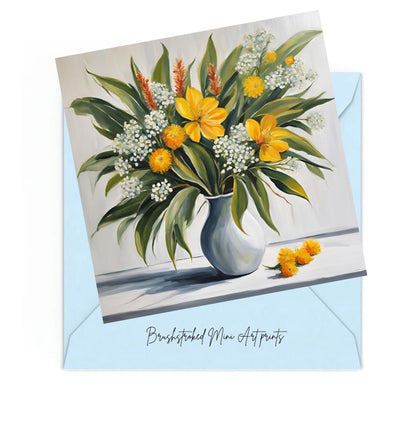 yellow and white flowers in white vase with green leaves mini art print.