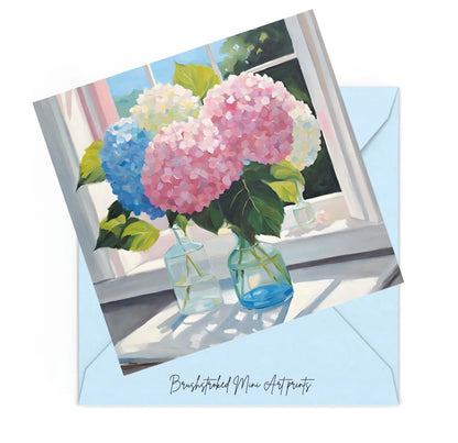 pink, white and blue hydrangeas in glass vases on table near window mini art print