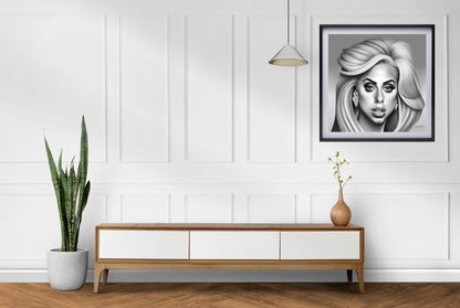 black and white portrait  of lady gaga framed art hanging in room 