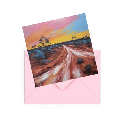 mini art print of an Australian dessert sunset , on top of a Pink envelope