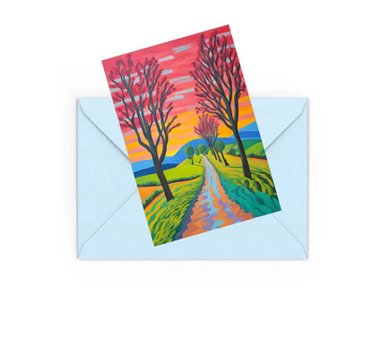 abstract colourful landscape art with trees, path, hills and wild floers mini art print, on top of a Blue envelope