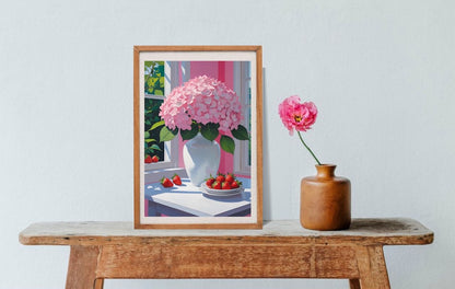 Framed artwork of a pink flower arrangement  with strawberries on a wooden table with a small vase of flowers.
