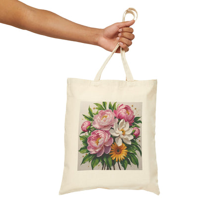 person holding a canvas tote bag which has a pretty pink white and yellow flower print.