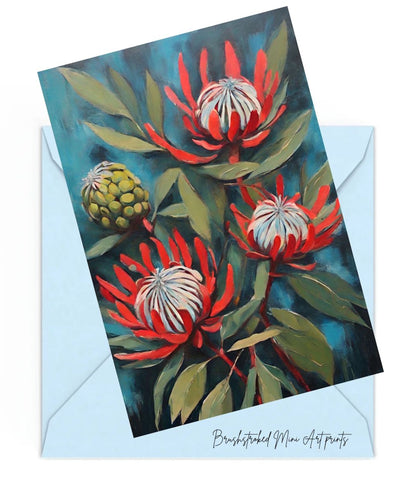red proteas and green leaves painted on a blue background mini art print on top of a blue envelope