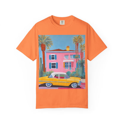 orange t shirt printed on the front with a colourful palm springs pink house and a yellow vintage car.